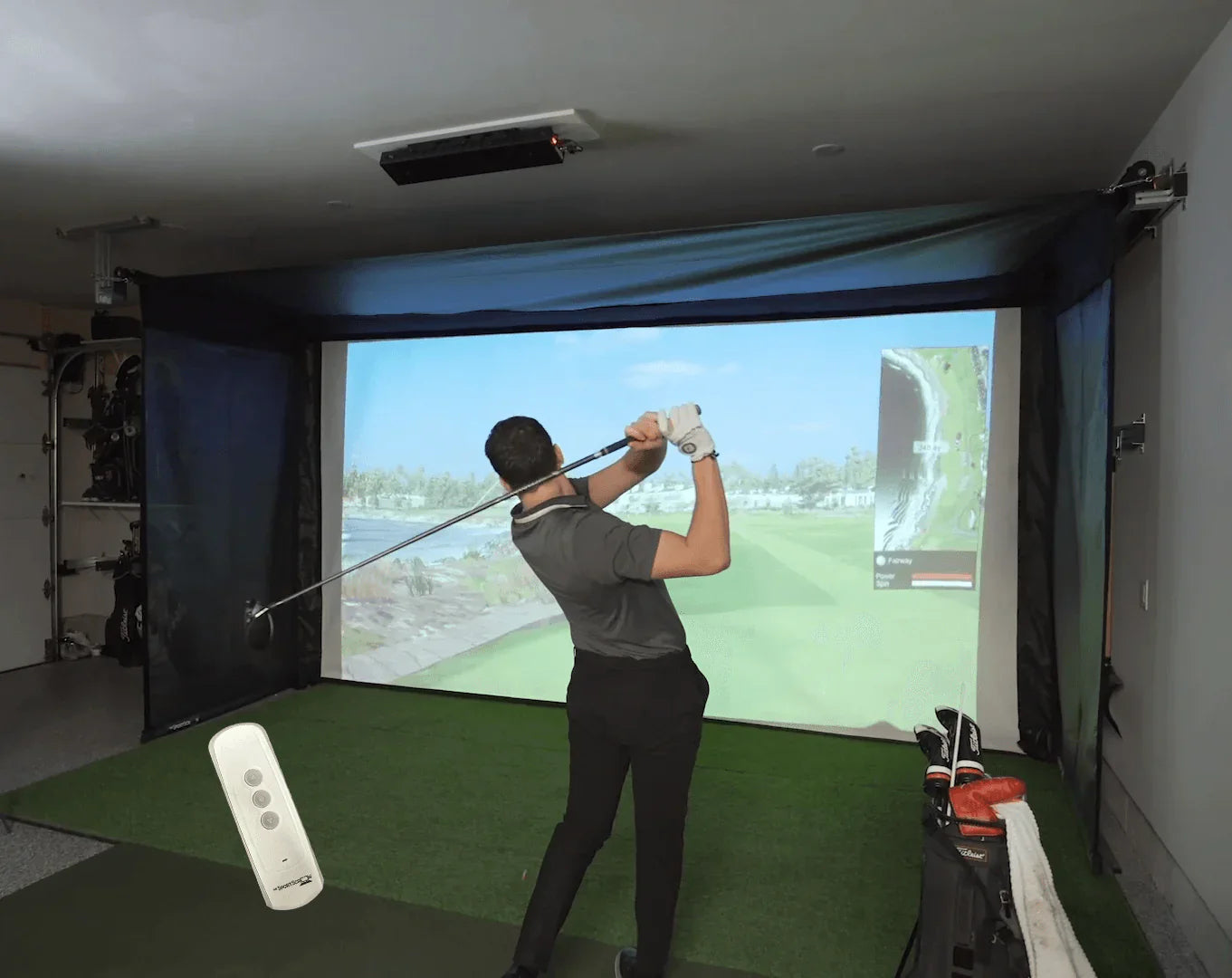 The SportScreen Vanish Series Retractable Golf Studio golf simulator enclosure for indoor golf simulator setup