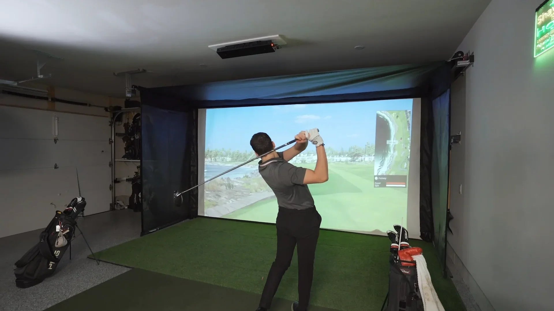 The SportScreen Vanish Series Retractable Golf Studio golf simulator enclosure for indoor golf simulator setup